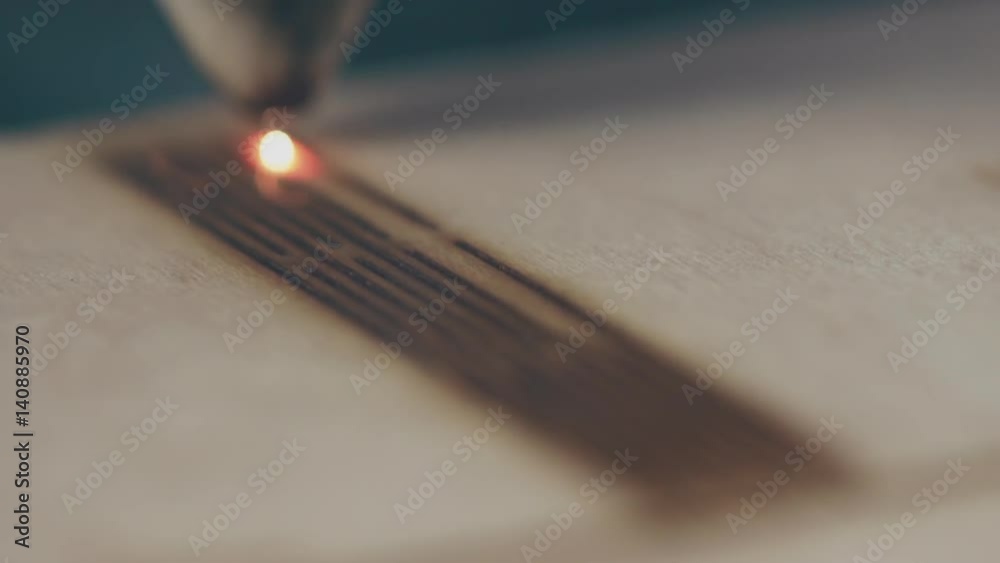 Laser cutting on wood closeup. Slow motion. Laser cutting on wood closeup. Slow motion.