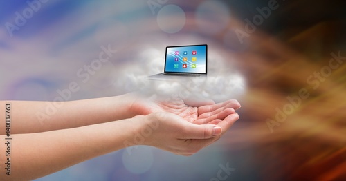 Conceptual image of cupped hands with cloud and laptop