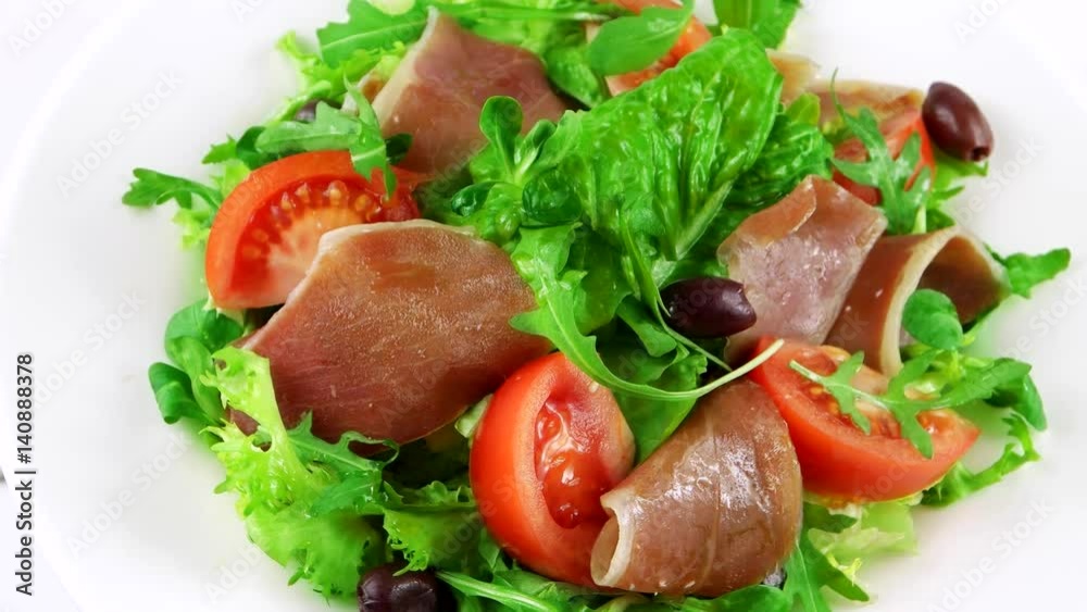 Restaurant salad with ham (Sliced Spanish), lettuce leaf, arugula, tomatoes and olives, loop
Restaurant salad with ham (Sliced Spanish), lettuce leaf, arugula, tomatoes and olives, loop