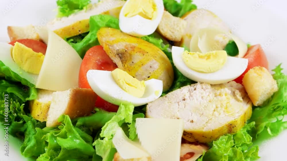 Close-up view of fresh Caesar salad with chicken, eggs, croutons, parmesan cheese and tomatoes, loop
Close-up view of fresh Caesar salad with chicken, eggs, croutons, parmesan cheese and tomatoes, loop