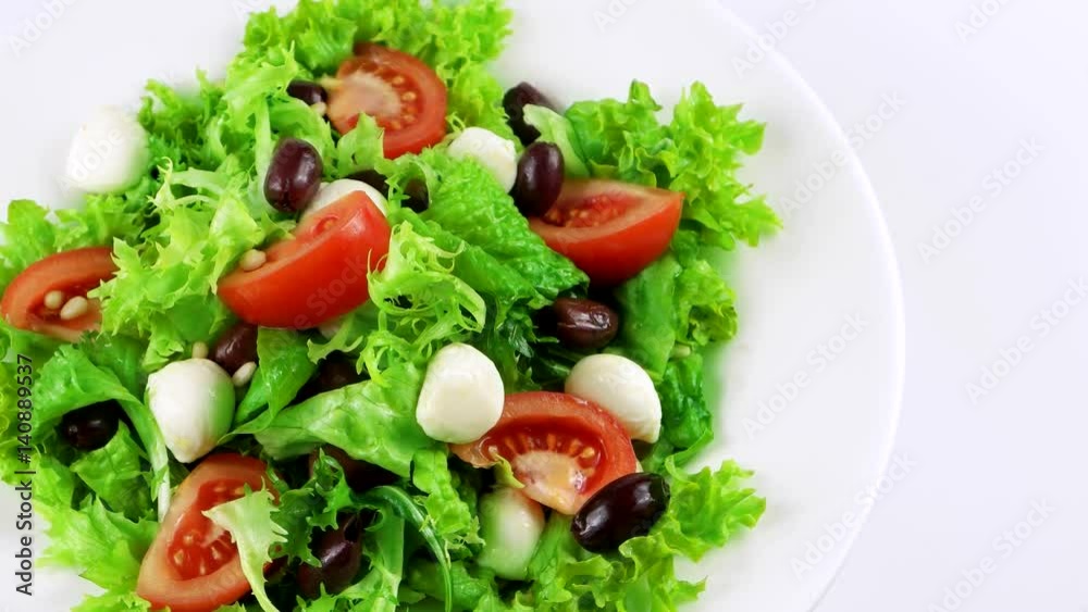 Organic vegetarian salad with mozzarella, pine nuts, lettuce leaf, tomatoes and olives, copy space in right side, loop
Organic vegetarian salad with mozzarella, pine nuts, lettuce leaf, tomatoes and olives, copy space in right side, loop
