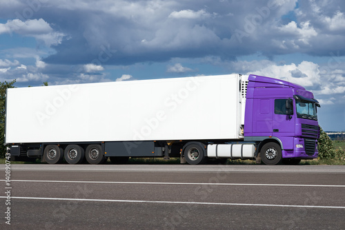 Truck on road with white blank container, blue sky, cargo transportation concept