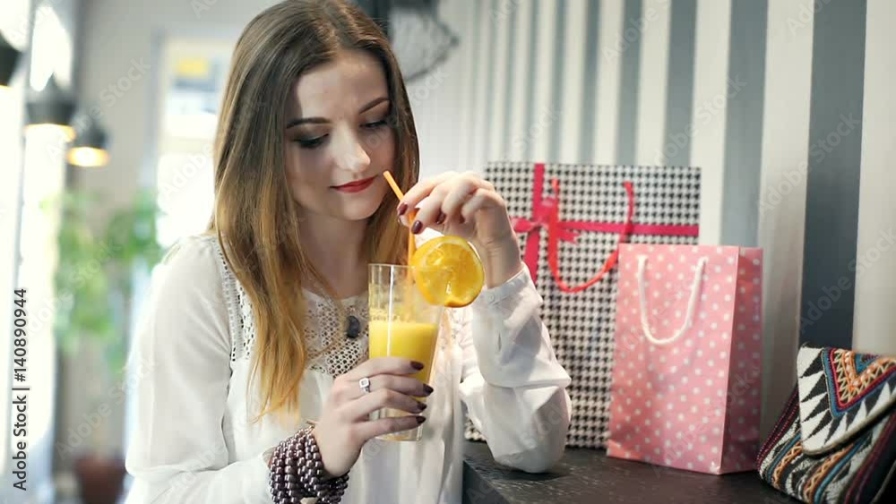 Happy girl relaxing in the cafe and drinking orange juice, steadycam shot
Happy girl relaxing in the cafe and drinking orange juice, steadycam shot