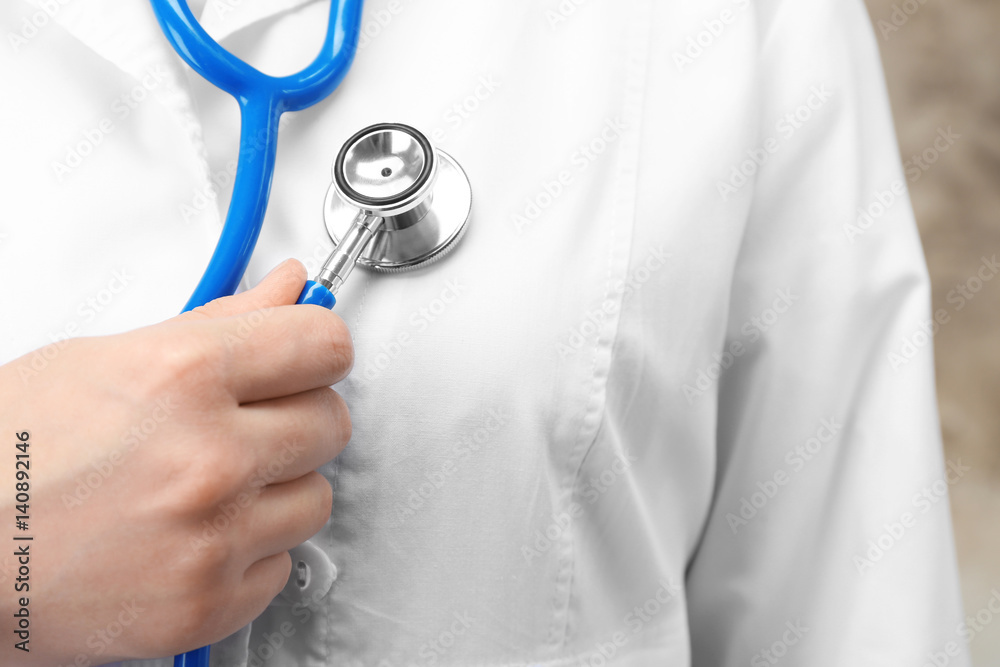 Doctor holding stethoscope, closeup Doctor holding stethoscope, closeup