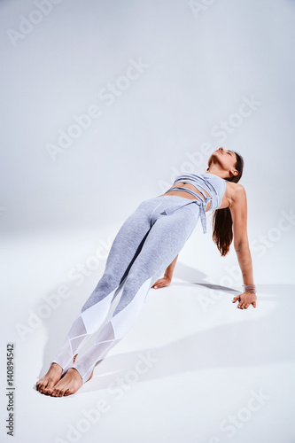 Woman doing yoga isolated on white background