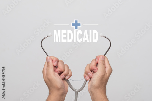Hands holding a stethoscope and word 
