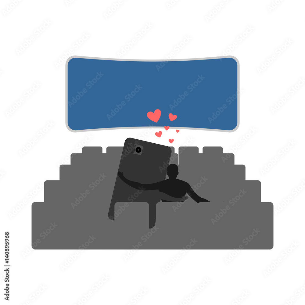 Lover of gadgets. Man and smartphone In cinema, watching movie. Always together device. I love my phone. Lover of gadgets. Man and smartphone In cinema, watching movie. Always together device. I love my phone.