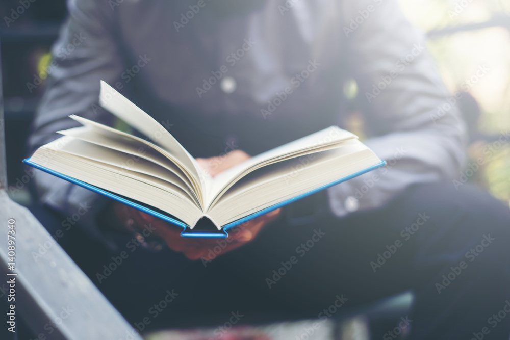 Man relaxing at home while sitting and reading book. Man relaxing at home while sitting and reading book.