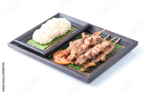 Thai styled grilled pork and sticky rice isolated on white