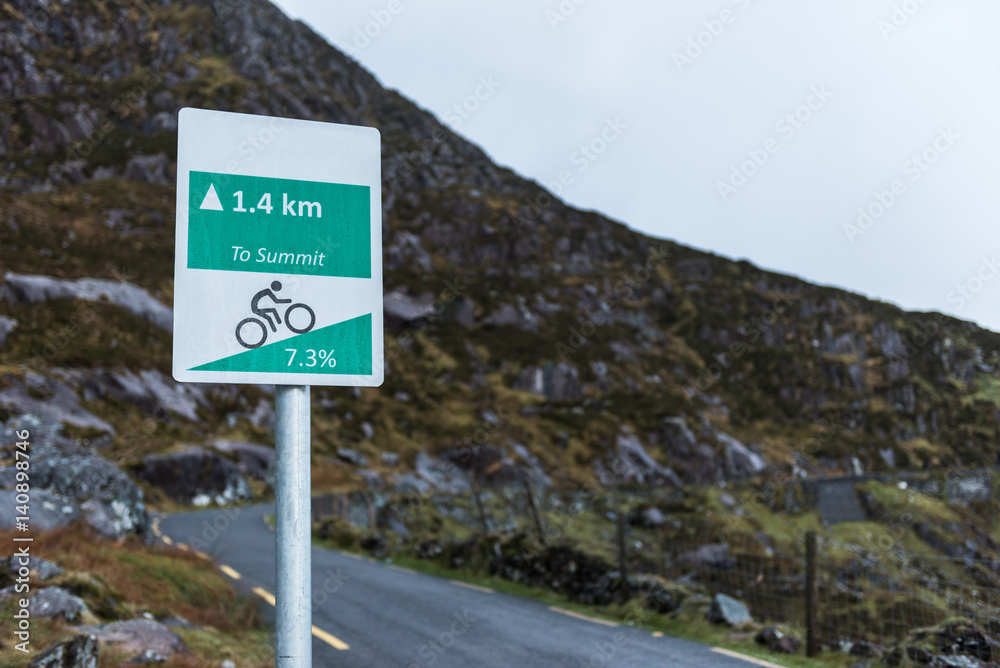 Distance sign to the  top of a steep climb for cyclists on the Connor pass in the Dingle peninsula in County Kerry, Ireland