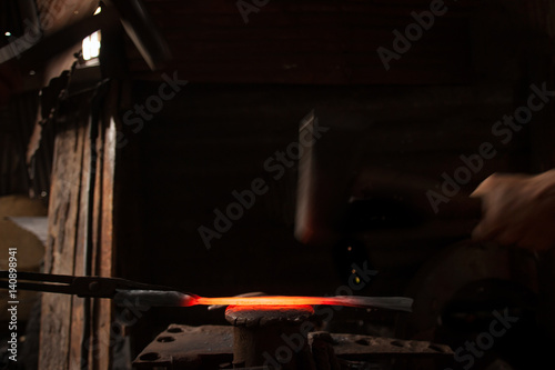 Blacksmith forging a knife