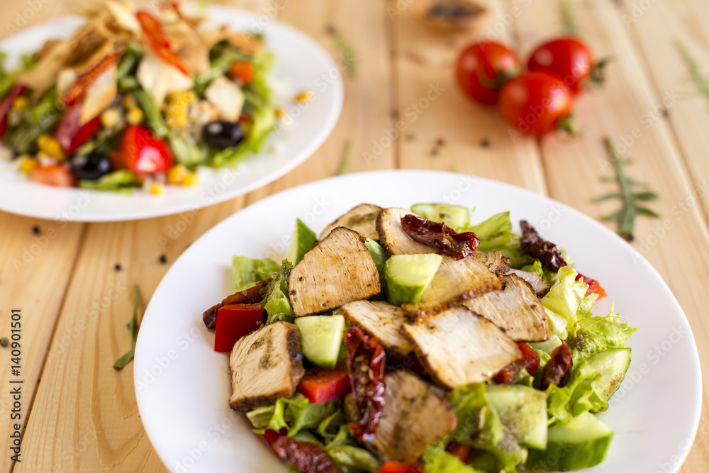 Homemade fresh organic salad bowl horizontal shot on wood background Homemade fresh organic salad bowl horizontal shot on wood background