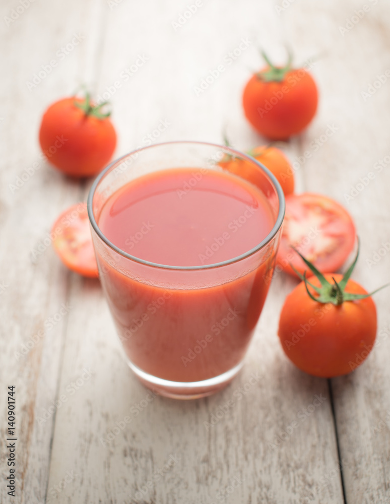 Glass of tomato juice on wooden table Glass of tomato juice on wooden table