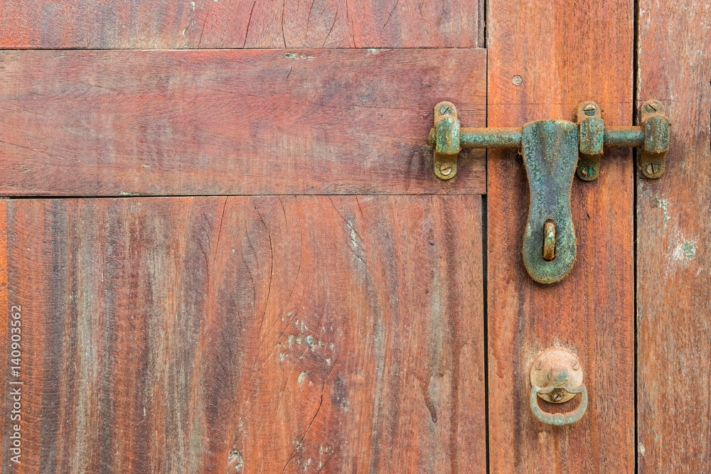 Old rustic wooden background: detail of an old wooden door with a latch. Old colonial house in Ancient Dutch Galle fort in Sri Lanka. Old rustic wooden background: detail of an old wooden door with a latch. Old colonial house in Ancient Dutch Galle fort in Sri Lanka.