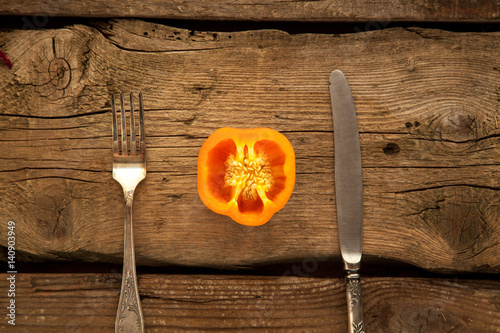 Pepper as sorce of vitamins for vegeterians and people on diet on wooden background. photo