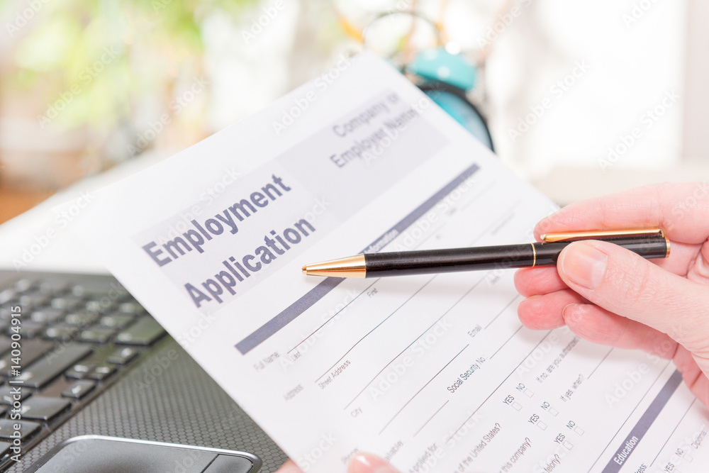 Holding blank employment application form Holding blank employment application form
