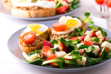 Salad with strawberry, spinach and goat cheese.  Bruschettes