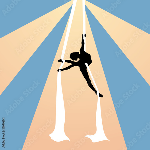 Air gymnast on silk ribbons under the dome of circus