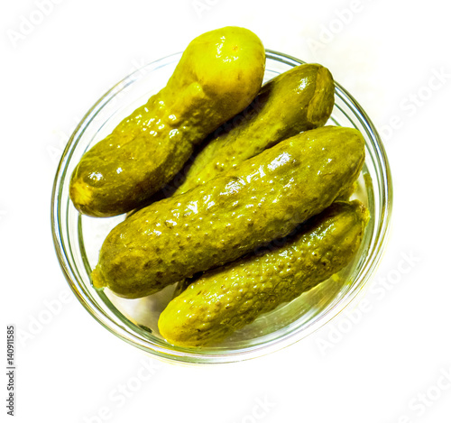 Pickled green gherkins in small glass plate