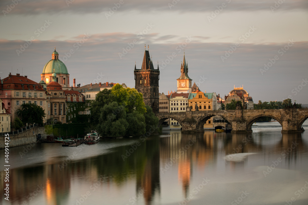 The Charles Bridge in Prague at sunrise and the surrounding houses