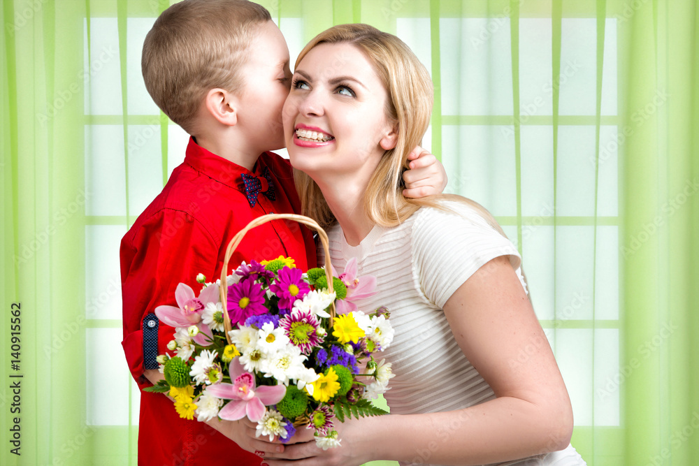 Young beautiful mother with her son.To whisper a secret in your ear. Woman and child with bouquet of flowers. Spring family holiday concept. Women's day. Young beautiful mother with her son.To whisper a secret in your ear. Woman and child with bouquet of flowers. Spring family holiday concept. Women's day.