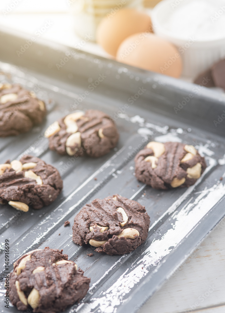 Delicious chocolate cookies with nuts on a baking tray Delicious chocolate cookies with nuts on a baking tray