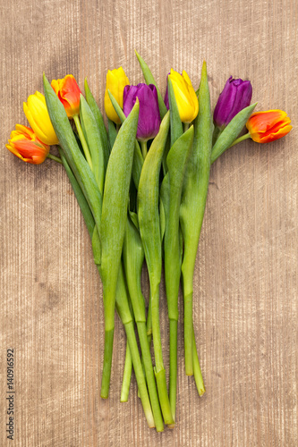 Bouquet of tulips on wooden background.Top view.