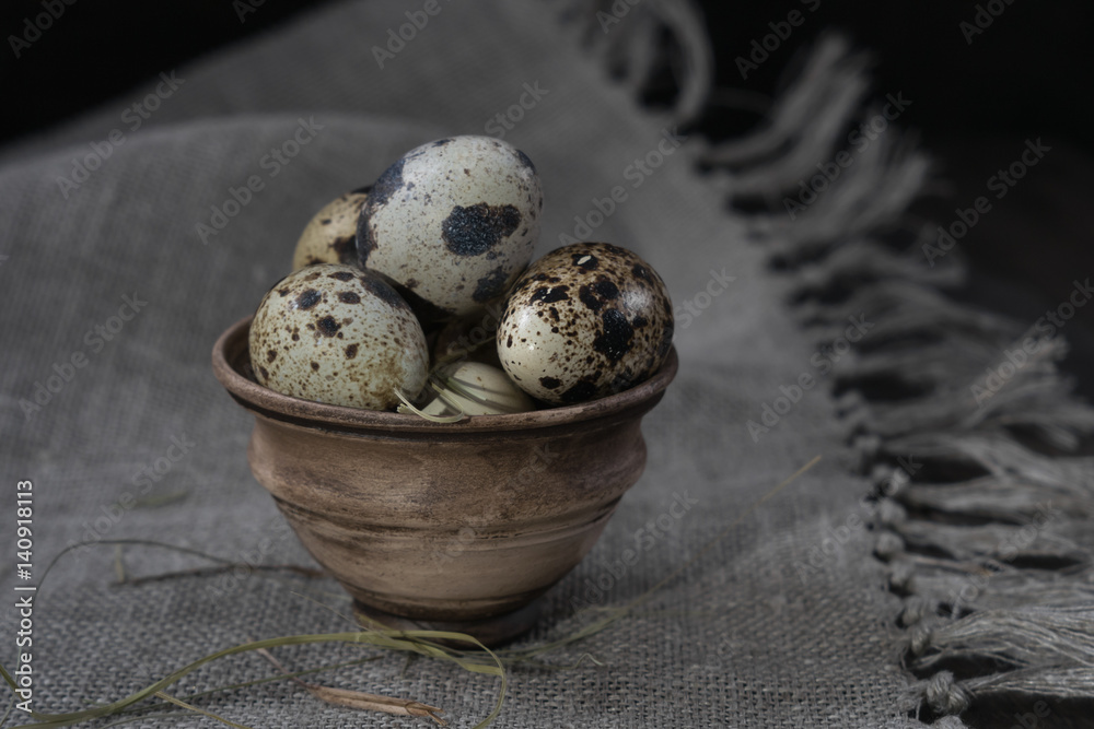 Quail eggs in clay pot on dark background. Eco products. Healthy food Quail eggs in clay pot on dark background. Eco products. Healthy food