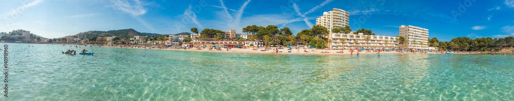 beautiful panorama of beach at paguera with clear water and hotels in the background