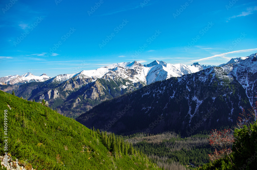 Autumn landscape of great peaks covered with snow. Tatry.