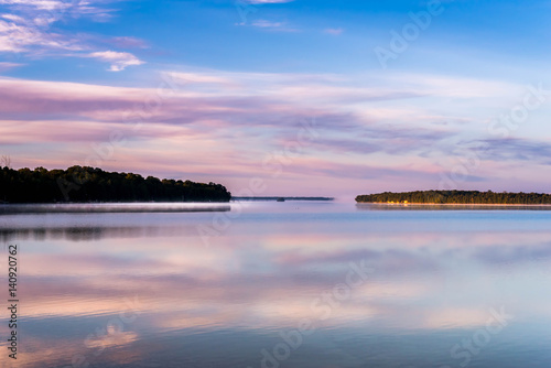 Lake at sunrise with vivid colors reflected in water of Lake Manitoulin © joanncampbell