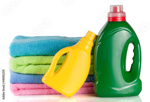 bottle laundry detergent and conditioner with towels isolated on white background