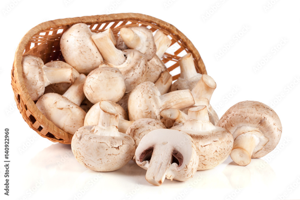 Champignon mushrooms in a wicker basket isolated on white background Champignon mushrooms in a wicker basket isolated on white background