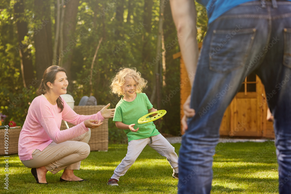 Fototapeta premium Boy in garden with parents