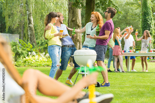 Young people grilling in garden