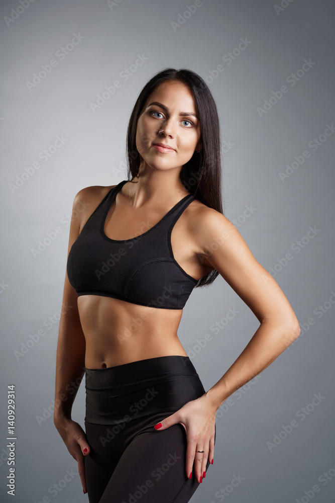 Pretty brunette fitness trainer studio portrait