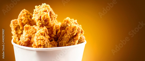 Fried Chicken wings and legs. Bucket full of crispy kentucky fried chicken