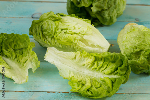 Romaine lettuce, isolated. Blue wooden table.