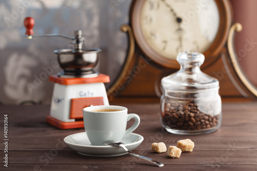 Cup of coffee with jar with coffee beans