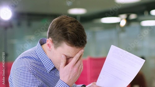 Clouse up of young businessman criticizes the work of a colleague