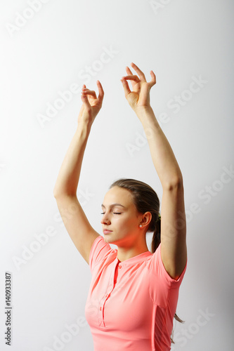 Young healthy yoga woman practicing yoga with closed eyes