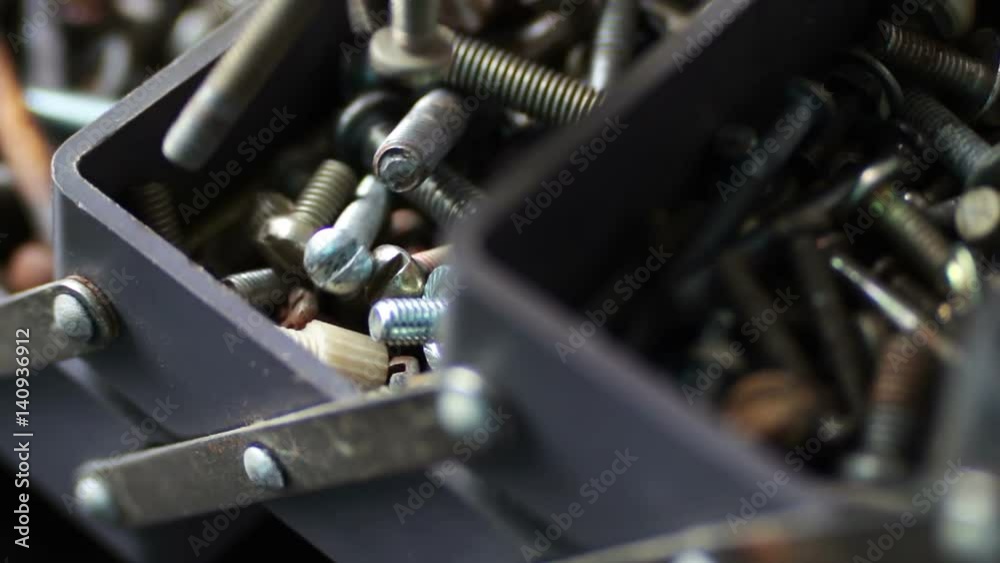Smooth slider shots of various hardware fasteners, nuts, bolts, screws, in box Smooth slider shots of various hardware fasteners, nuts, bolts, screws, in box