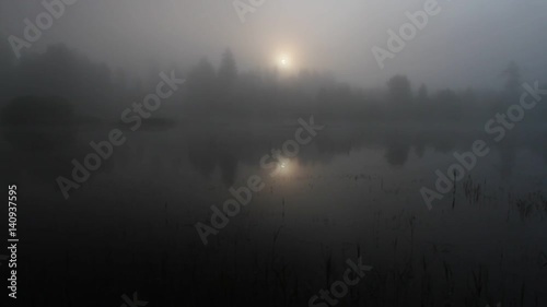 Misty swamp and lake in the early morning
