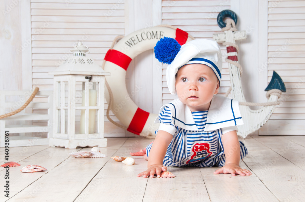 A little sailor traveler sits on the background of an anchor and a circle. A little sailor traveler sits on the background of an anchor and a circle.