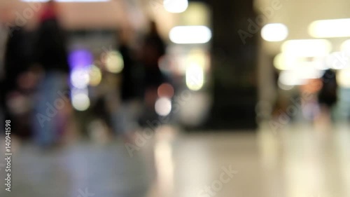 Blur bokeh of people walking in train station in the UK.