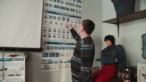 Class driving school, road signs, teacher man wearing glasses lectures a class