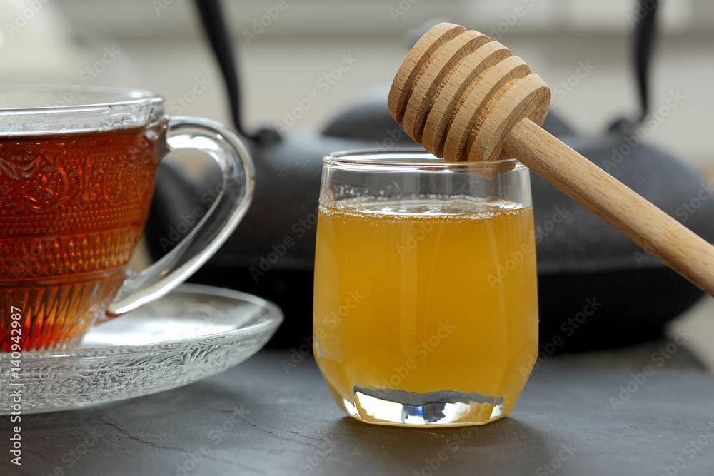 cup of tea with honey on a table cup of tea with honey on a table