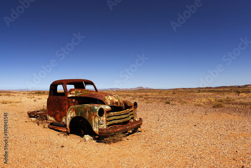 rusted car hood in the African desert