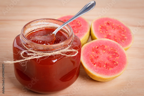 Brazilian dessert goiabada - jam of guava with fresh goiaba on wooden background. Selective focus
