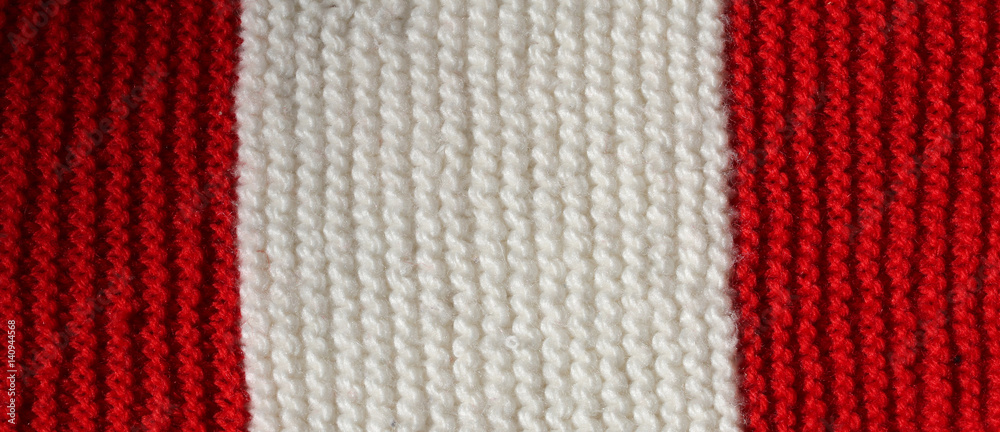 Red and White wool texture of a winter dress made by hand